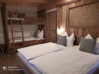 A bed or beds in a room at Alp-IN Lodges Kaprun
