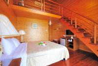 a bedroom with a large bed with a staircase at Aurora in Wujie