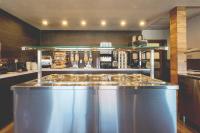 a kitchen with a counter top in a kitchen at Hotel Continental Centre-Ville in Val-dʼOr