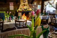 a table with a vase of flowers on a table at Family Hotel Chichin in Bansko