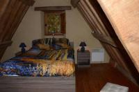 a bedroom with a large bed in a room at Gîte 3 pers Jacuzzi extérieur sous bulle, possibilité table d&#39;hôtes le soir in Tréduder