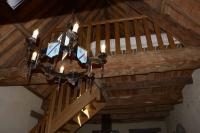 a chandelier hanging from the ceiling of a room at Gîte 3 pers Jacuzzi extérieur sous bulle, possibilité table d&#39;hôtes le soir in Tréduder