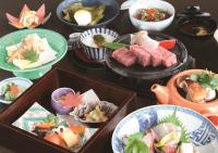 a table topped with different types of food in bowls at Kitabiwako Hotel Grazie in Nagahama