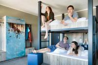 a group of people sitting on bunk beds at WIROtel Warnemünde in Warnemünde