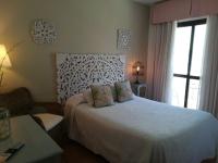 a bedroom with a white bed and a window at Macavi in Rota