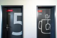 two black elevators with the words f and s on them at WIROtel Warnemünde in Warnemünde