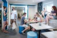 a group of people sitting at tables in a room at WIROtel Warnemünde in Warnemünde