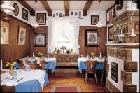 a dining room with two tables and a couch at Hotel Landgasthof Birkenfelder Hof in Birkenfeld