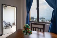a dining room with a table with a plant on it at Paretto Seaview Hotel in Pantai Cenang
