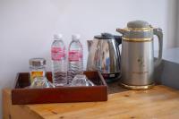a tray with bottles of water and a coffee maker at Paretto Seaview Hotel in Pantai Cenang