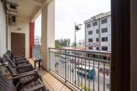 a balcony with chairs and a view of a street at Paretto Seaview Hotel in Pantai Cenang