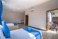 a hotel room with a bed and a chair at Paretto Seaview Hotel in Pantai Cenang