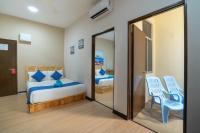 a bedroom with a bed and a mirror at Paretto Seaview Hotel in Pantai Cenang