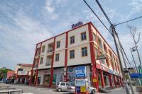 a red and white building on the corner of a street at Paretto Seaview Hotel in Pantai Cenang