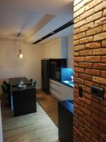 Televízia a/alebo spoločenská miestnosť v ubytovaní Apartament na Mazurach