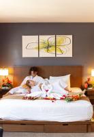 a man and a woman and a child laying on a bed at VIVE Hotel Waikiki in Honolulu