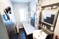 a bathroom with a sink and a toilet and a mirror at Hotel Tanne in Saalfeld