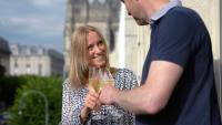 a man and a woman holding a glass of wine at La Demeure des Sacres - Cathédrale in Reims