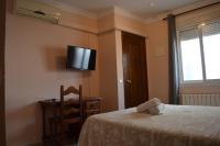 Postel nebo postele na pokoji v ubytování Hotel Doña Carmen