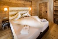 a bedroom with a bed with white pillows at Hundehotel Riederhof in Ried im Oberinntal