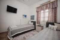 A bed or beds in a room at Mythic House