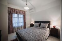 A bed or beds in a room at Mythic House