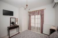 A bed or beds in a room at Mythic House