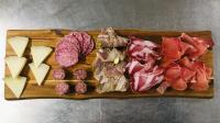 a wooden cutting board with different types of meat and cheese at Albergo Ristorante Terme in Acquasanta Terme