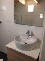 a bathroom with a white sink and a mirror at Serviced Apartement Sonnleitner in Furth