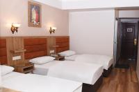 A bed or beds in a room at Hotel Grand Umit