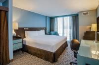 a hotel room with a bed and a desk at Crowne Plaza Chicago O'Hare Hotel & Conference Center by IHG in Rosemont