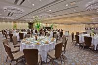 a banquet hall with white tables and chairs at Crowne Plaza Chicago O'Hare Hotel & Conference Center by IHG in Rosemont