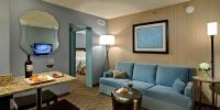 a living room with a blue couch in a hotel room at Crowne Plaza Chicago O'Hare Hotel & Conference Center by IHG in Rosemont