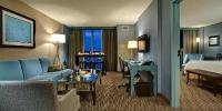 a hotel room with a couch and a bed at Crowne Plaza Chicago O'Hare Hotel & Conference Center by IHG in Rosemont