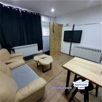 a living room with a couch and a table and a tv at Apartment Lena Centar - best value, best choice! in Osijek