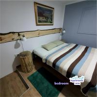 a bedroom with a bed and a wooden stump at Apartment Lena Centar - best value, best choice! in Osijek