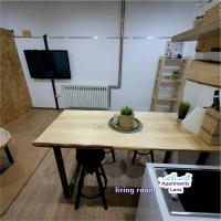 a wooden table in a living room with a tv at Apartment Lena Centar - best value, best choice! in Osijek