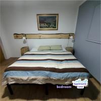 a bedroom with a bed with a striped blanket at Apartment Lena Centar - best value, best choice! in Osijek