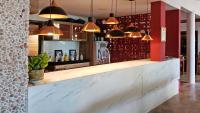 a bar with pendant lights above a counter at Villa Pantai Milagres Exclusive Hotel in São Miguel dos Milagres