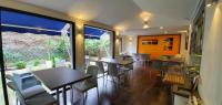 a restaurant with tables and chairs and a large window at The Originals City, Hôtel Les Océanes, Lorient in Lorient