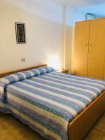 A bed or beds in a room at Condominio Monaco