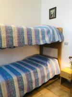 A bed or beds in a room at Condominio Monaco
