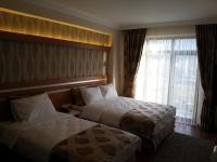 Postel nebo postele na pokoji v ubytování Gevher Hotel