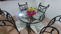 a glass table with a bowl of fruit on it at KAZADIDOU - Résidence Grand Cap - Vue Mer et Montagne - Piscine in Le Gosier