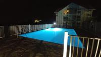 a swimming pool at night in front of a house at KAZADIDOU - Résidence Grand Cap - Vue Mer et Montagne - Piscine in Le Gosier