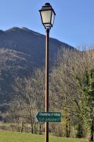 a street light with a street sign on it at Lo Saunei in Laruns