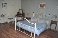 a bedroom with a bed and a clock and a table at Lo Saunei in Laruns