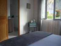 a bedroom with a bed and a window at Lo Saunei in Laruns