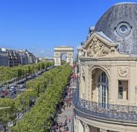 a view of a building and a street with trees at Champs Elysees Flat in Paris