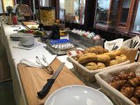 a buffet with bread and other foods on a table at Residence St Havel Prague Old Town in Prague